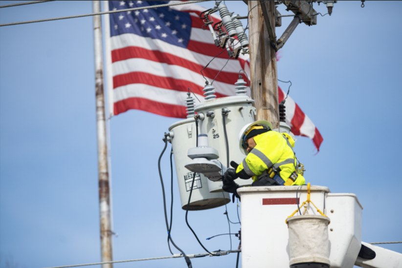 A service tech installing a Ubicquia node on a utility pole